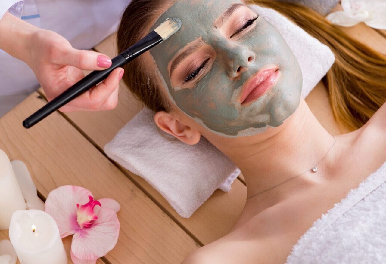 Young woman in spa health concept with face mask